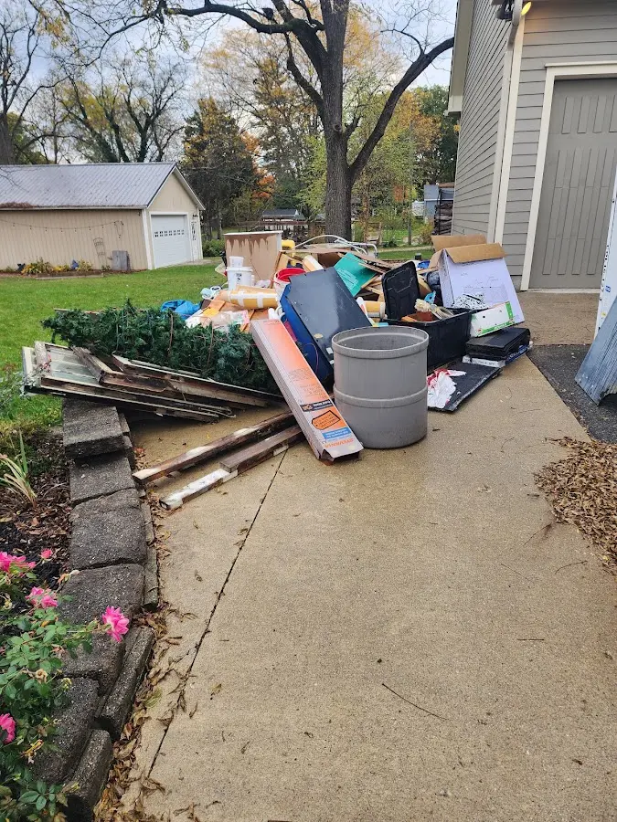 Dumpster being loaded with debris for Residential Dumpster Rental in Madill